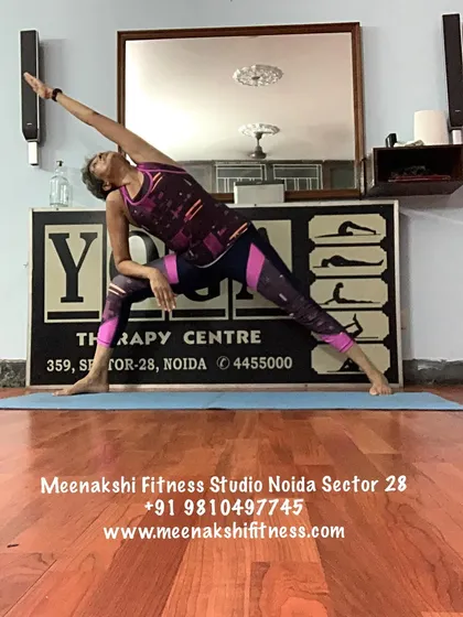 This is the Extended Side Angle Pose, a posture that builds strength in the legs and creates space along the side of the body. We always modify poses like this to ensure they are safe and feel good for you.