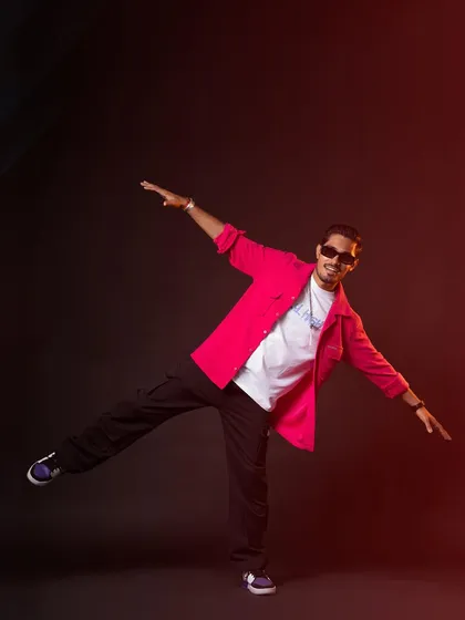 Another dynamic pose in the pink shirt, showing movement and fun. This kind of styling is great for social media content and personal branding.