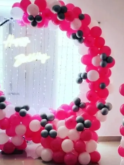 Another perspective of the popular pink and white circular balloon frame. This design is versatile and can be customized with different colors and lighting for any celebration.