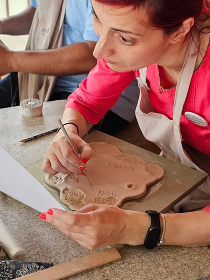 A few snapshots of corporate team members completely absorbed in their creative process. They are making everything from decorative nameplates to unique bowls during our hand-building workshop.