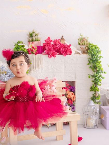 A curious expression from this little one, looking right at the camera during her colorful, floral-themed shoot.