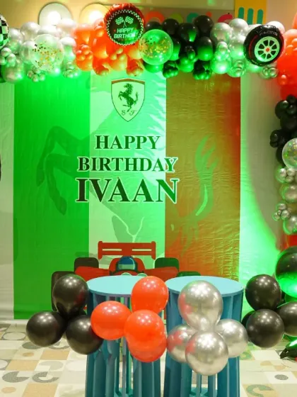 A full view of the Ferrari-themed birthday decor, featuring the Italian flag colors and a sleek race car backdrop. It's a sophisticated and exciting theme.