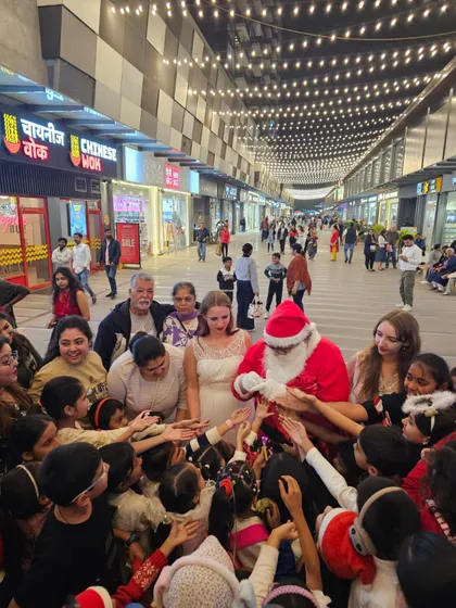 There's nothing more rewarding than seeing the pure joy on children's faces. Here, our Santa Claus entertainer is surrounded by an excited crowd of kids at a mall's Christmas event, creating a truly magical holiday memory for them.
