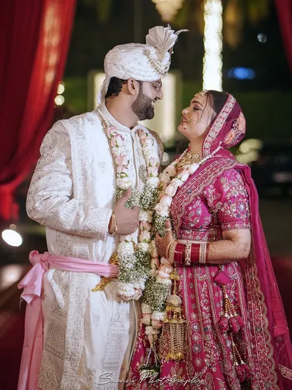 A beautiful portrait of the couple after their Varmala ceremony, looking at each other with love.