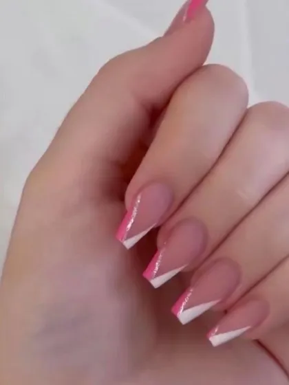 A modern twist on a classic, these square-shaped extensions feature a sharp, geometric V-shaped French tip design in both pink and white.