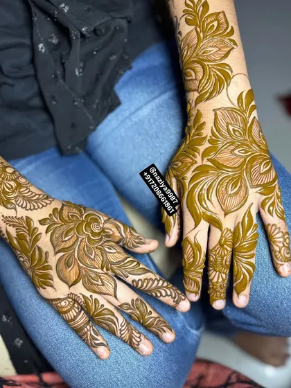 A beautiful example of matching floral designs on both hands, perfect for a coordinated party look. The patterns are light and airy, with plenty of open space.