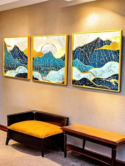 This set of three crystal paintings depicts a stylized mountain range at sunrise. The combination of blue, gold, and white creates a serene and majestic landscape, ideal for a hallway or office space.