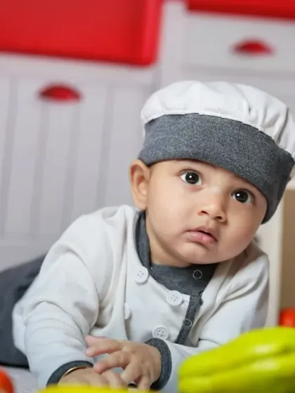 A close-up of the adorable chef. Even at this age, a costume and a fun environment can bring out their curious nature.