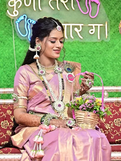 This candid shot shows the client holding a basket of flowers, her makeup looking soft and elegant. It's a perfect example of a look that is both traditional and effortlessly beautiful.