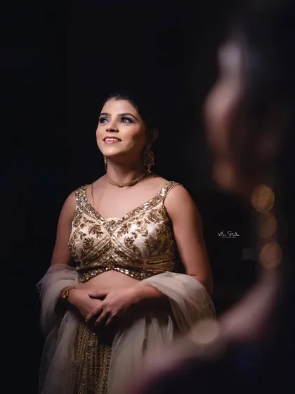 A creative portrait using a reflection. The bride-to-be looks up towards the light, while her reflection is captured in the foreground, adding depth and artistry to the shot.