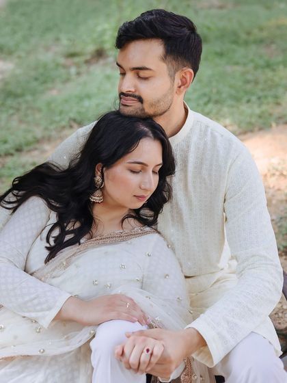 A tender moment with the bride resting her head on the groom's shoulder, both with their eyes closed.