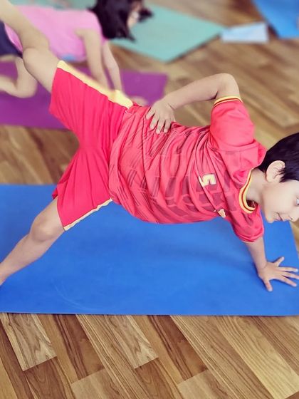 This young student is working on a variation of Vasisthasana, or side plank pose. It is a fantastic way to build core and arm strength while improving balance.