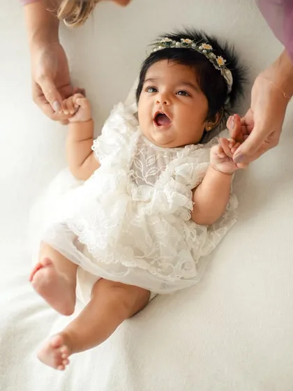 A happy, expressive moment from a baby girl. Capturing these little yawns and stretches adds so much personality to the gallery.