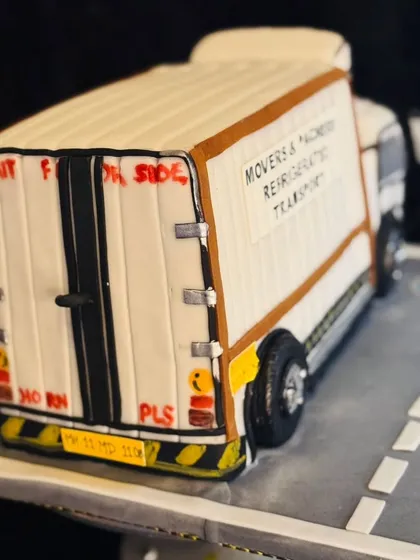 The back of the truck cake, featuring classic Indian truck art elements like 'Horn OK Please' and 'Wait for Side', all hand-painted for an authentic touch.