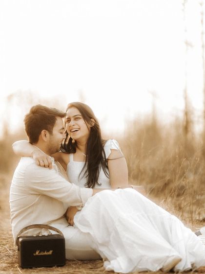 A burst of genuine laughter during a relaxed outdoor session. This candid photo perfectly captures the couple's joyful spirit and easy chemistry.