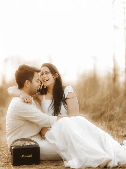 A burst of genuine laughter during a relaxed outdoor session. This candid photo perfectly captures the couple's joyful spirit and easy chemistry.