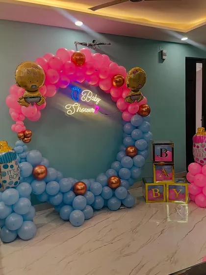 A baby shower decoration with a half-and-half design, using pink and blue balloons. This is great when the baby's gender is a surprise or for a fun theme.