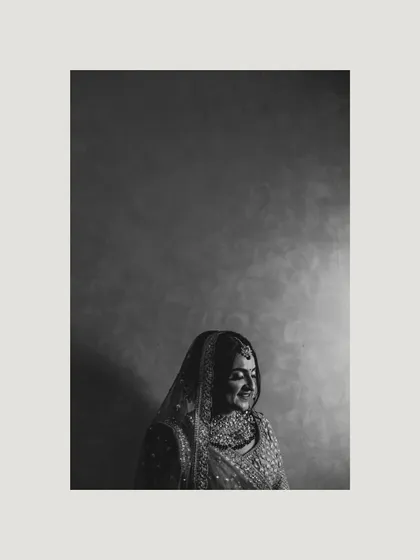 A moody and artistic black and white portrait of the bride, using shadow and light to create a sense of quiet elegance.