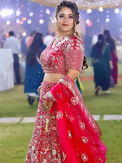 A side profile showing the intricate braided hairstyle and the glowing makeup.