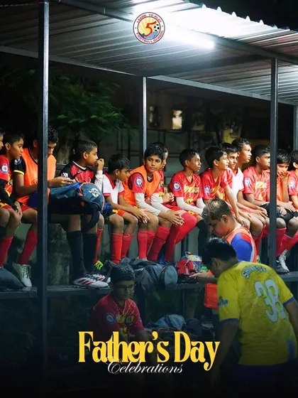 Players watching from the sidelines during the Father's Day celebrations.
