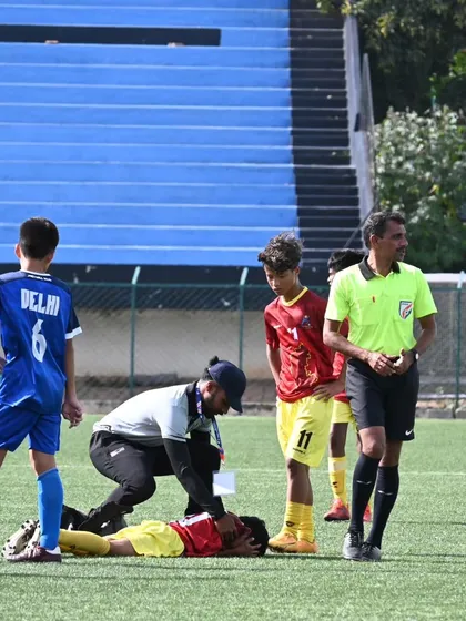 In the heat of the moment, immediate care is crucial. Here I am providing on-field first aid to a young football player during a match, ensuring a swift and professional response to a sports injury.