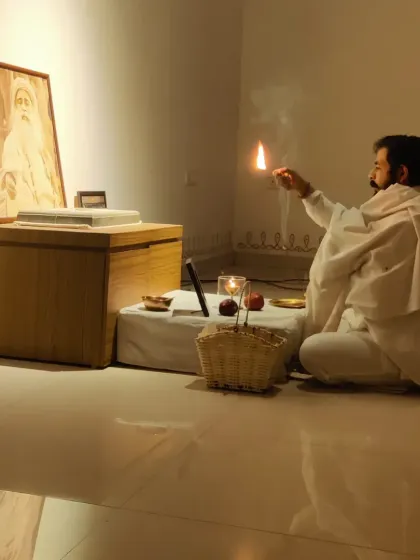 I am performing the Sadhguru Sanidhi Pooja, a simple yet powerful process to invoke the Guru's presence. This ritual of offering light and devotion creates a space of profound stillness and transformation for all who gather.