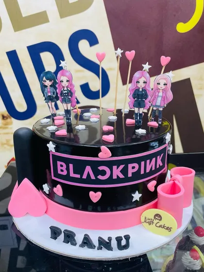 For the K-Pop fans, we designed this 2kg Blackpink-themed cake. It features the band's iconic logo on a black and pink base, topped with character figures and hearts, capturing the fun and energy of the music group.