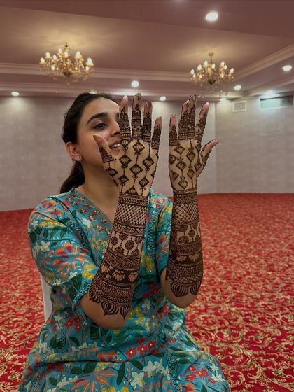 A fun shot of the bride showing the back of her hands, featuring a modern geometric design.