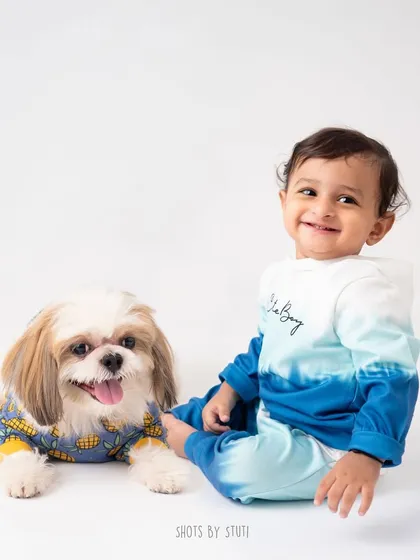 Two adorable munchkins in the studio. This photo perfectly captures the sweet and playful friendship between a baby and his dog.