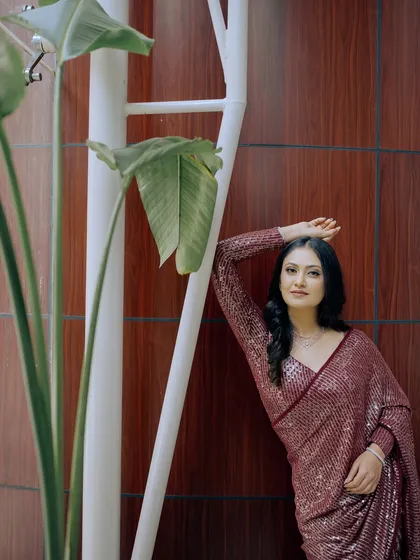 A classy and elegant engagement look in a sequin saree, perfect for a modern bride.