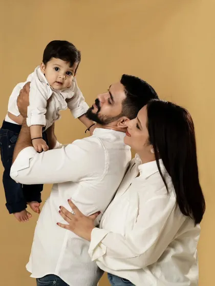 A playful moment between parents and their baby. We love capturing these candid interactions that show the fun and love in your family.