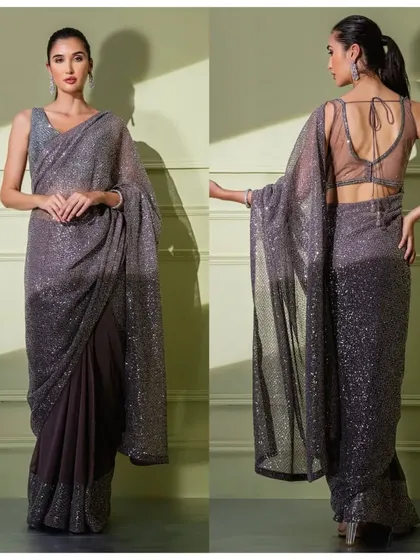 This grey ombre saree is fully sequined for a glamorous effect. It's paired with a sheer back blouse, offering a modern and alluring look.