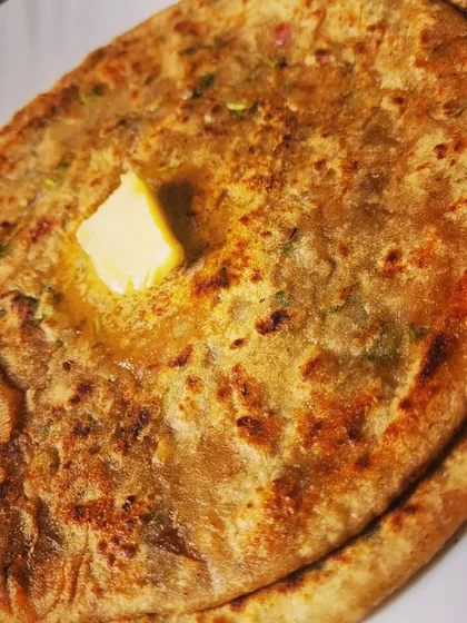 The perfect bite of Aloo Paratha, golden brown and filled with a delicious potato mixture.
