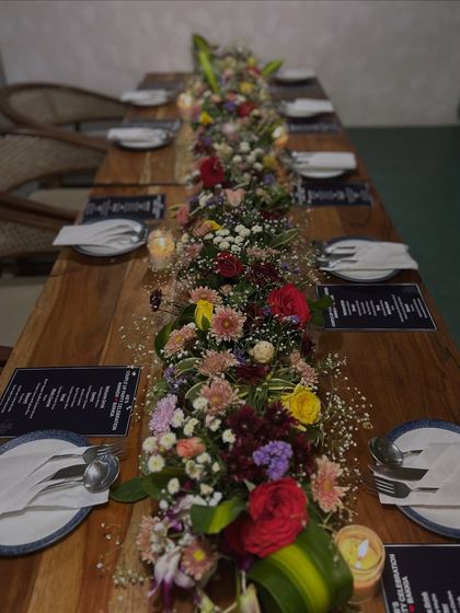 An overhead view of the beautifully set dining table, showcasing the floral runner and place settings.