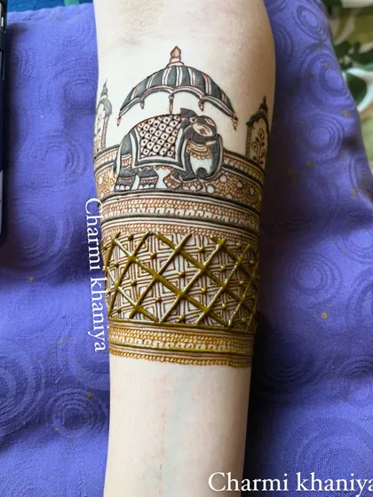 A simple yet royal bridal startup design. This arm band features a majestic elephant under a royal umbrella, a symbol of strength and prosperity to begin the wedding festivities.