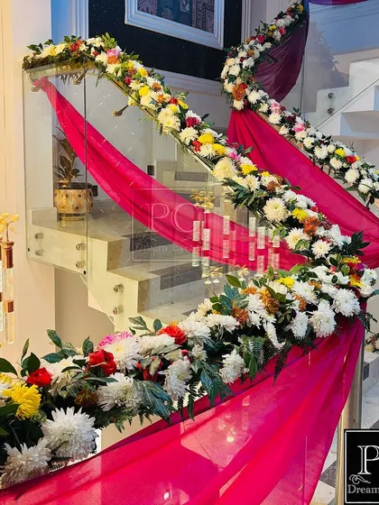A closer look at the staircase decor, showing the mix of colorful flowers and the delicate hanging elements that add a touch of elegance.