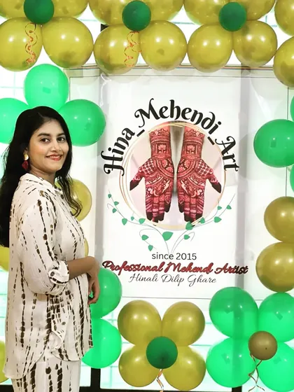 Here I am with my banner at a student event. Teaching and sharing my passion for mehendi art is something I truly enjoy.