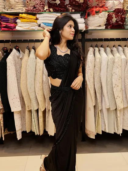 A full view of the black pre-draped saree, highlighting its flattering silhouette.