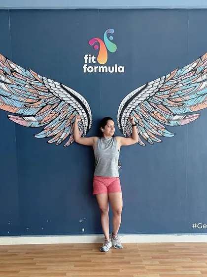 Posing with the wings after a great workout. It's a symbol of the transformation and freedom that fitness brings.