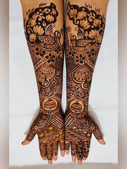 Another angle of the peacock and floral engagement design, showing the beautiful flow of the patterns on the arms.