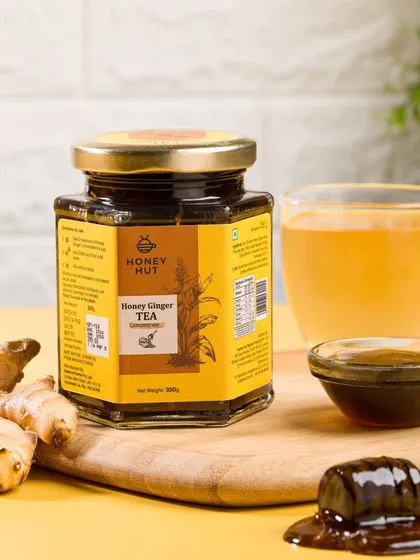 A simple, clean setup of honey ginger tea with a hot cup of tea. This image is perfect for e-commerce listings and focuses on the product's primary use.