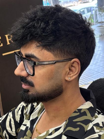 Another angle showcasing the sharp definition and fade of the beard. This style requires careful detailing to create a look that is both bold and exceptionally neat.