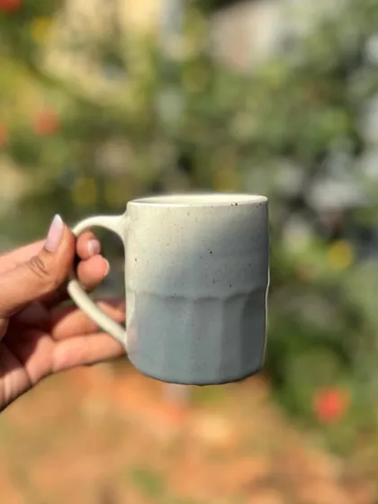 Our White Rabbit glaze on a faceted mug. The little speckles in the glaze give it so much character and warmth.
