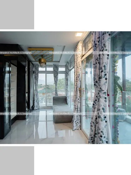 This interior shot shows the walk-in closet area with floor-to-ceiling glass windows. The design maximizes natural light and provides stunning views, making even a functional space feel open and luxurious.