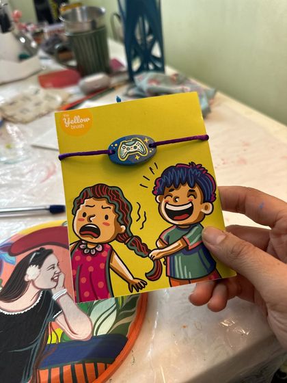 A fun Rakhi for a gamer brother, featuring a hand-painted video game controller.