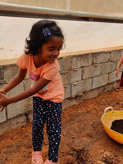 A young visitor gets her hands in the soil during a youth training program. We believe direct interaction with nature is the best way to teach children about healthy eating and sustainable agricultural practices.