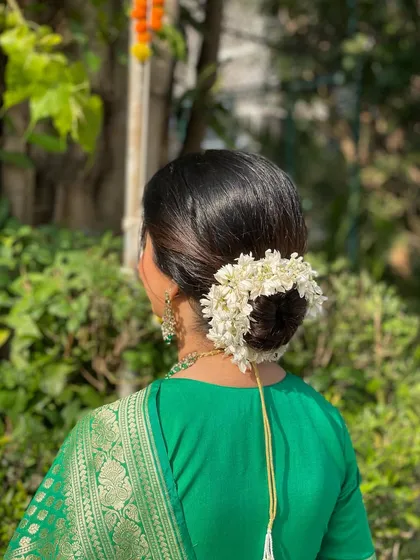 Another angle of the beautiful gajra bun, showing how it perfectly sits at the nape of the neck for a classic silhouette.
