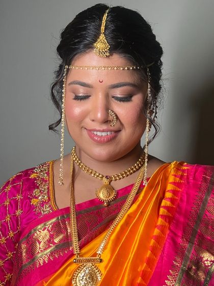 A moment of quiet elegance. The soft eye makeup and glowing skin create a timeless look that is perfect for a Maharashtrian wedding ceremony.