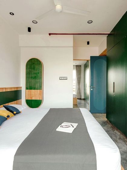 The full view of the T7 T8 master bedroom, showing how the green wardrobes and wall art create a cohesive and calming design.