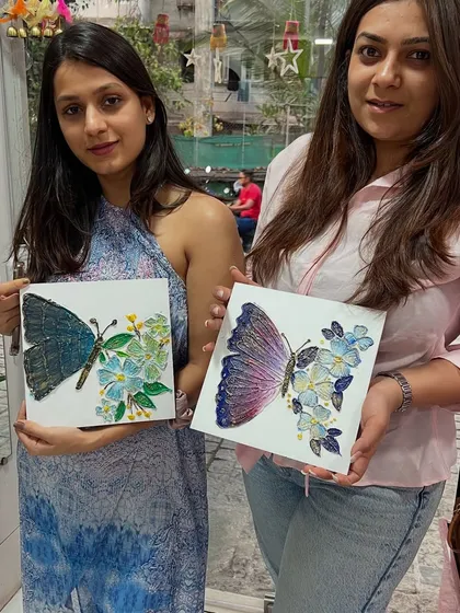 These two artists are showing off the beautiful butterfly-themed texture art they created. Texture art is great for beginners as it's very forgiving and allows you to build up layers to create a stunning 3D effect on canvas.